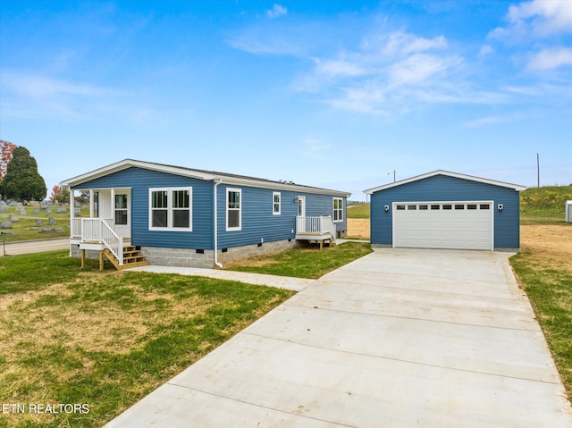 manufactured / mobile home with a detached garage, a front lawn, and crawl space