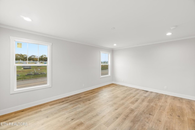empty room with crown molding, recessed lighting, and baseboards