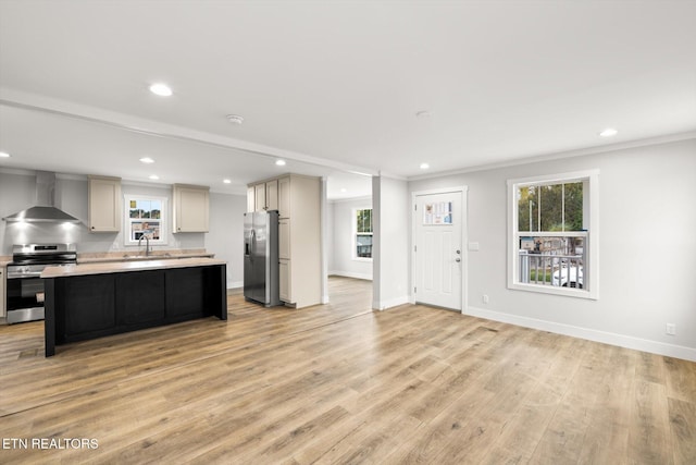 kitchen featuring wall chimney range hood, appliances with stainless steel finishes, recessed lighting, and light countertops