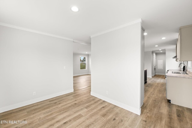 interior space with crown molding, recessed lighting, and a sink
