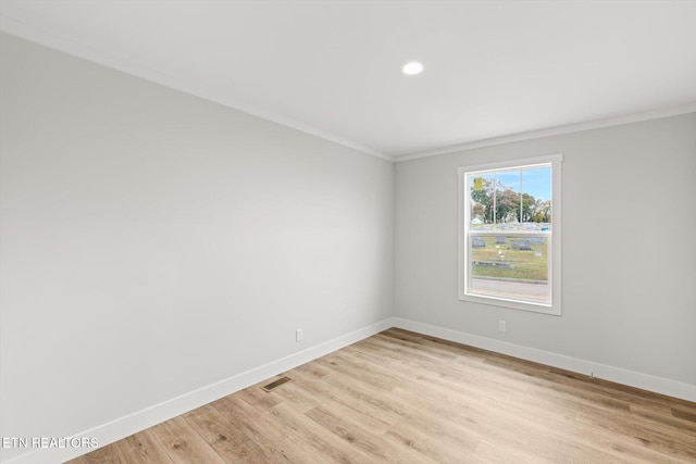 empty room featuring visible vents, baseboards, light wood finished floors, ornamental molding, and recessed lighting