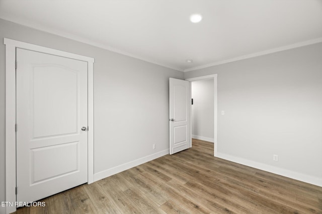 unfurnished bedroom featuring recessed lighting, baseboards, ornamental molding, and light wood finished floors