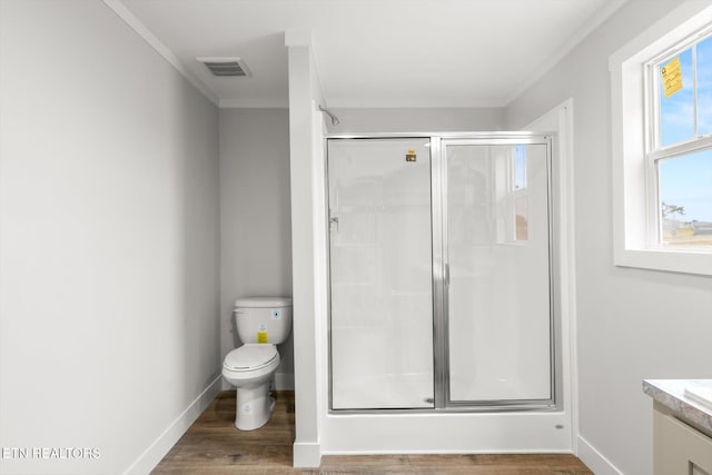 full bath with vanity, ornamental molding, toilet, and a shower stall