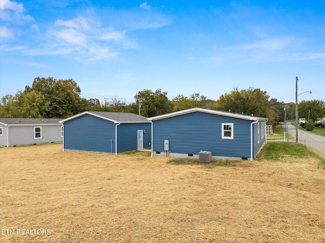 exterior space with central air condition unit and crawl space