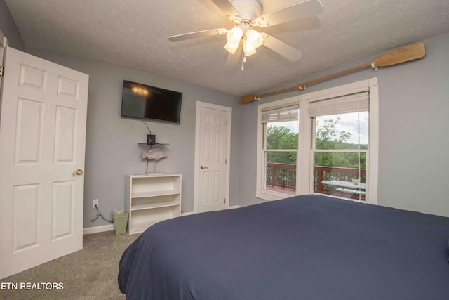 bedroom with baseboards, carpet flooring, a textured ceiling, and a ceiling fan