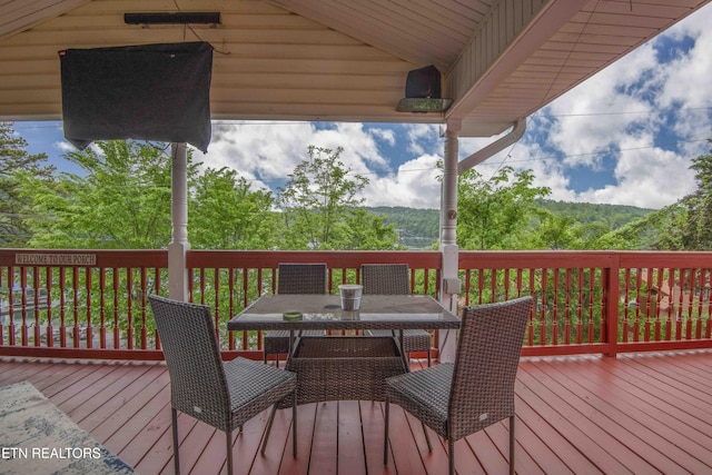 wooden deck with outdoor dining space
