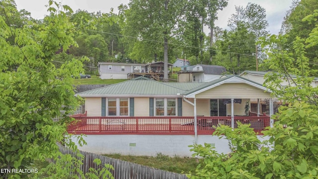 back of property featuring metal roof and crawl space