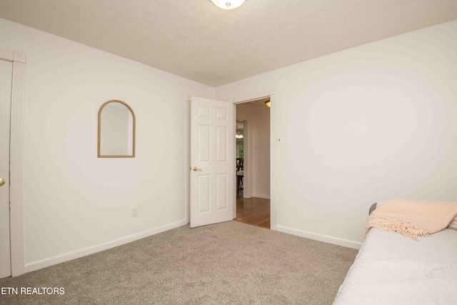 carpeted bedroom with baseboards