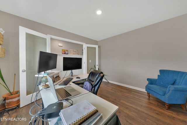 home office featuring baseboards and wood finished floors