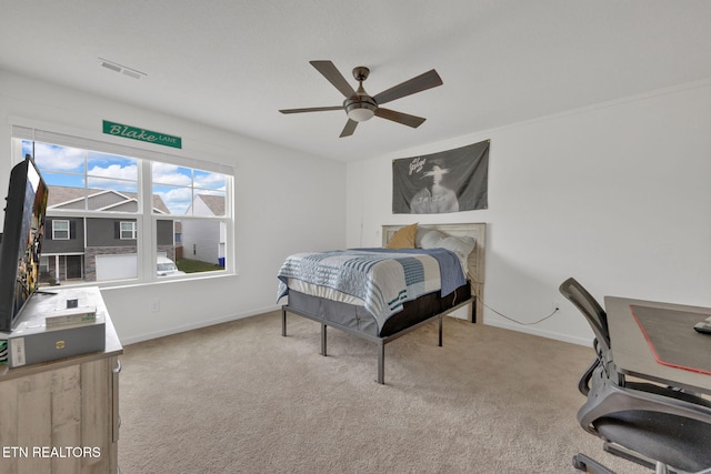 bedroom featuring visible vents, carpet flooring, baseboards, and a ceiling fan