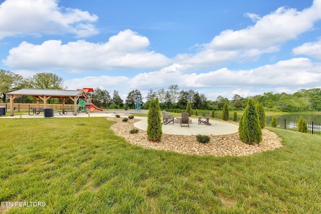 exterior space with fence, a gazebo, a yard, and an outdoor fire pit