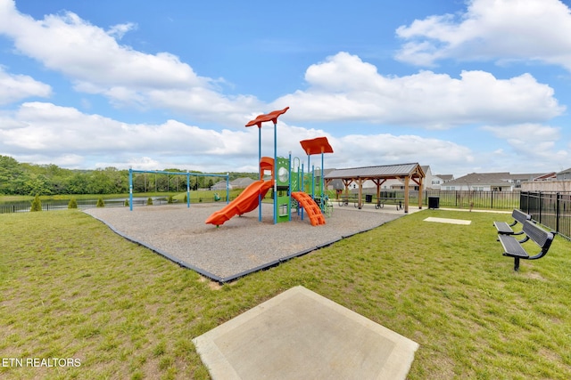 community play area featuring a gazebo, a lawn, and fence