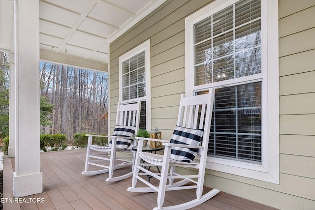 wooden terrace featuring covered porch