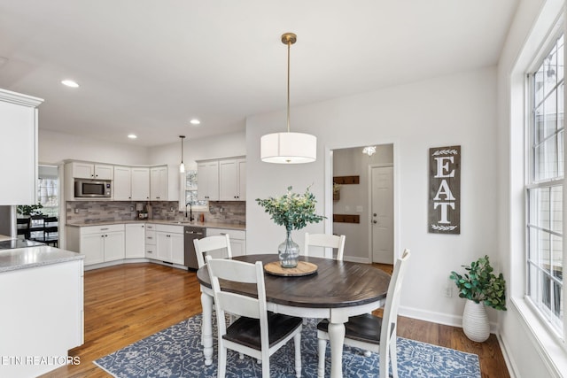 dining area with recessed lighting, baseboards, and wood finished floors