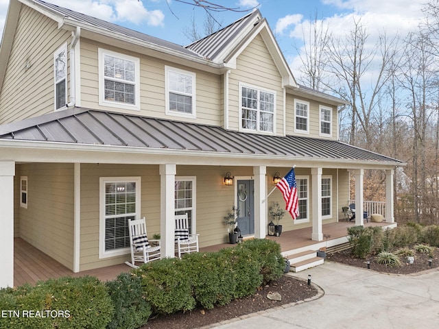 view of front of property with a standing seam roof, a porch, and metal roof