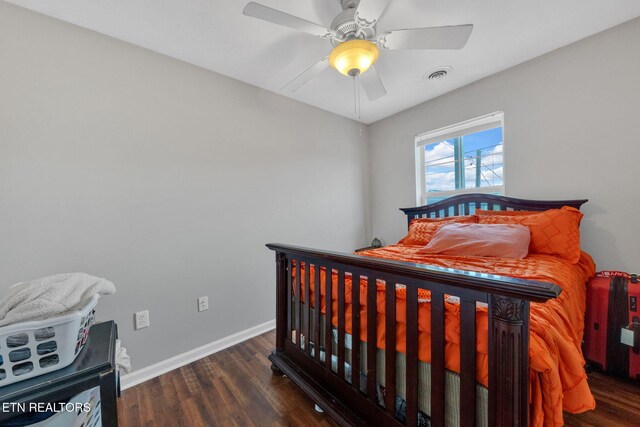 bedroom with baseboards, a ceiling fan, wood finished floors, and visible vents