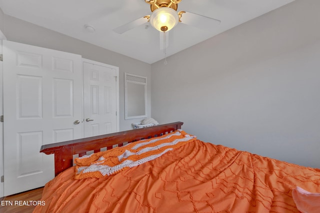 unfurnished bedroom with a closet, a ceiling fan, and wood finished floors