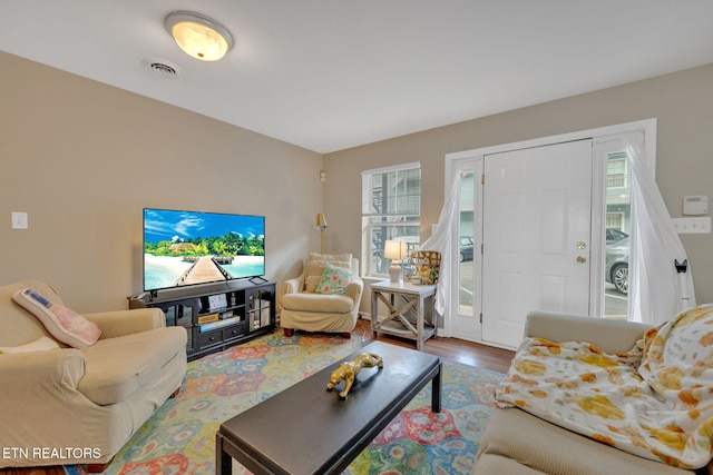 living room featuring wood finished floors and visible vents