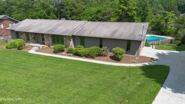 324 Trossachs Ln, Knoxville, TN 37922 - view of front facade featuring driveway, an outdoor pool, and stone siding