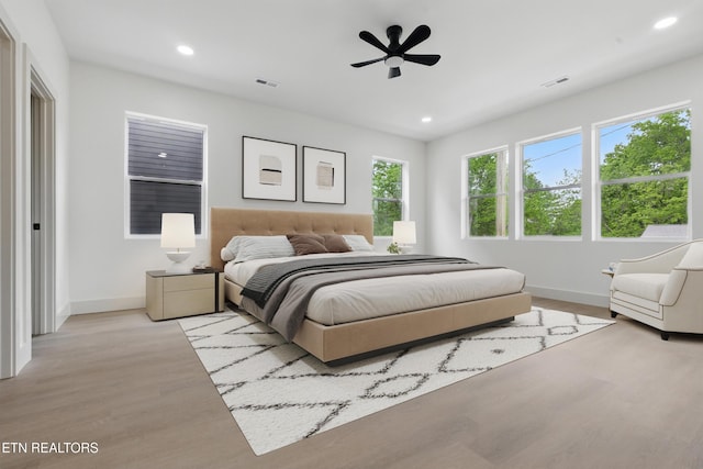bedroom with baseboards, multiple windows, recessed lighting, and visible vents