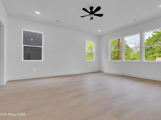 spare room featuring recessed lighting, light wood finished floors, and visible vents
