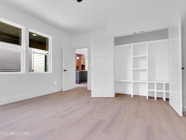 unfurnished bedroom featuring baseboards and light wood-type flooring