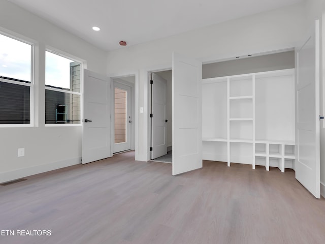 unfurnished bedroom featuring light wood-style floors, baseboards, recessed lighting, and visible vents