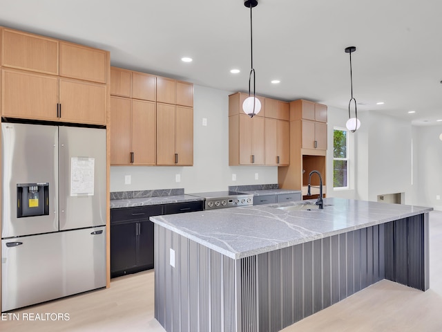 kitchen featuring light brown cabinets, light stone countertops, stainless steel fridge with ice dispenser, a sink, and light wood finished floors
