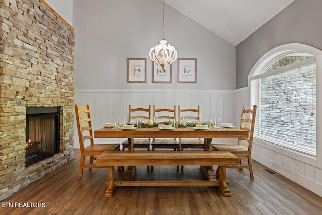 3487 Summit Trails Dr, Sevierville, TN 37862 - dining room with high vaulted ceiling, a notable chandelier, wainscoting, and wood finished floors