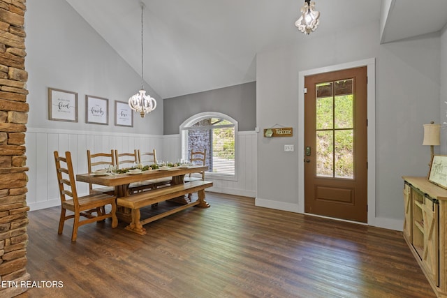 3487 Summit Trails Dr, Sevierville, TN 37862 - dining space featuring dark wood finished floors, a notable chandelier, a healthy amount of sunlight, and a wainscoted wall