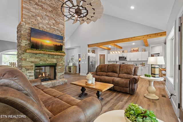 3487 Summit Trails Dr, Sevierville, TN 37862 - living area with a stone fireplace, recessed lighting, wood finished floors, and high vaulted ceiling