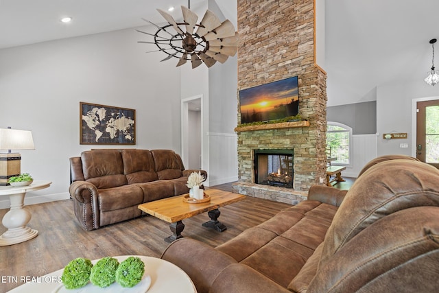 3487 Summit Trails Dr, Sevierville, TN 37862 - living area with high vaulted ceiling, ceiling fan, a fireplace, and wood finished floors
