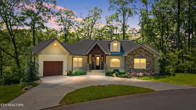 3487 Summit Trails Dr, Sevierville, TN 37862 - craftsman-style house featuring roof with shingles, a yard, concrete driveway, an attached garage, and stone siding