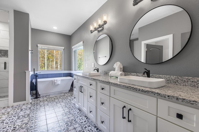 3487 Summit Trails Dr, Sevierville, TN 37862 - full bath with double vanity, a freestanding bath, a sink, and a stall shower