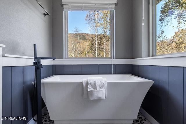 3487 Summit Trails Dr, Sevierville, TN 37862 - full bath featuring a wainscoted wall, a soaking tub, and a decorative wall