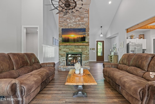 3487 Summit Trails Dr, Sevierville, TN 37862 - living area featuring dark wood-style flooring, ceiling fan, a fireplace, high vaulted ceiling, and baseboards