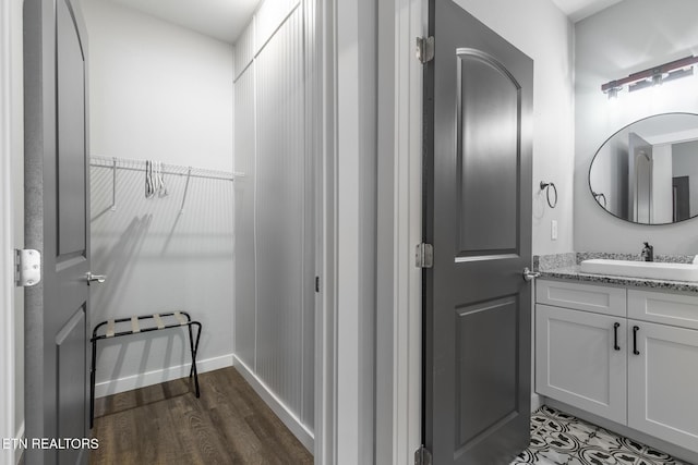 3487 Summit Trails Dr, Sevierville, TN 37862 - bathroom featuring vanity, baseboards, wood finished floors, and a spacious closet