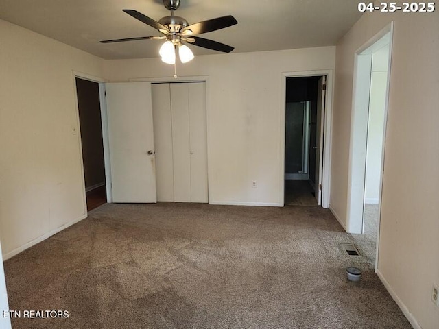 unfurnished bedroom featuring visible vents, baseboards, a closet, connected bathroom, and carpet