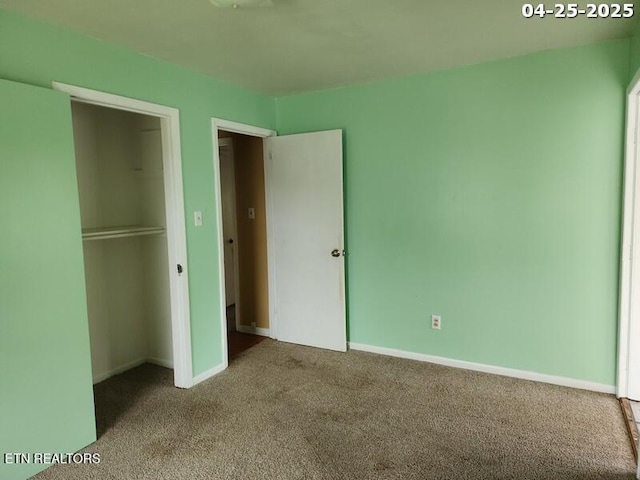 unfurnished bedroom featuring carpet flooring and baseboards