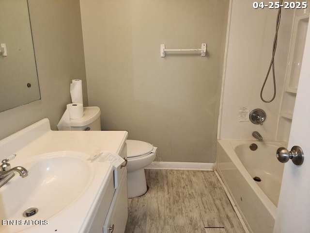 full bath featuring shower / tub combination, wood finished floors, baseboards, vanity, and toilet