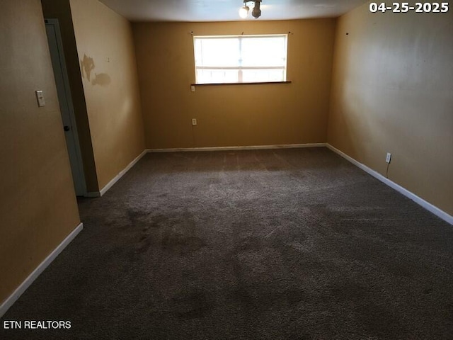 carpeted empty room with baseboards
