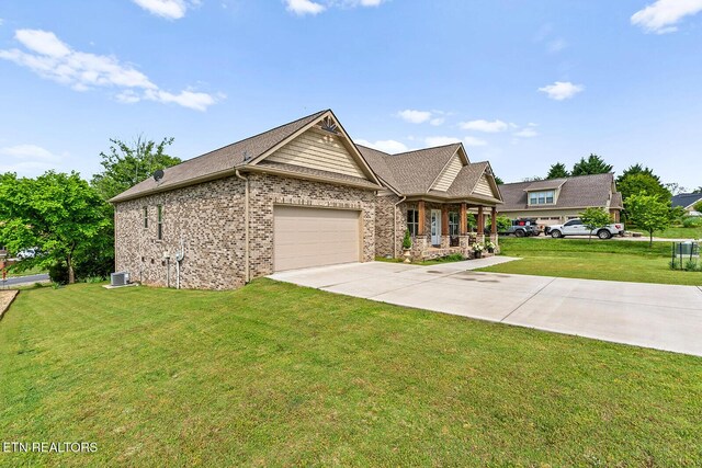 112 Naduli Trl, Vonore, TN 37885 - view of front of property with an attached garage, a front lawn, a porch, central AC unit, and driveway