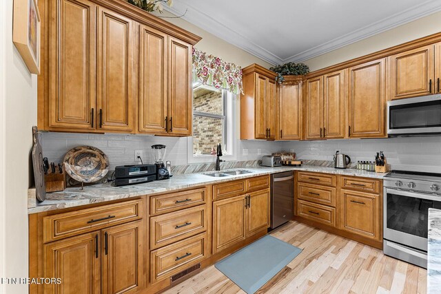 112 Naduli Trl, Vonore, TN 37885 - kitchen with tasteful backsplash, brown cabinets, a sink, light wood-style floors, and stainless steel appliances