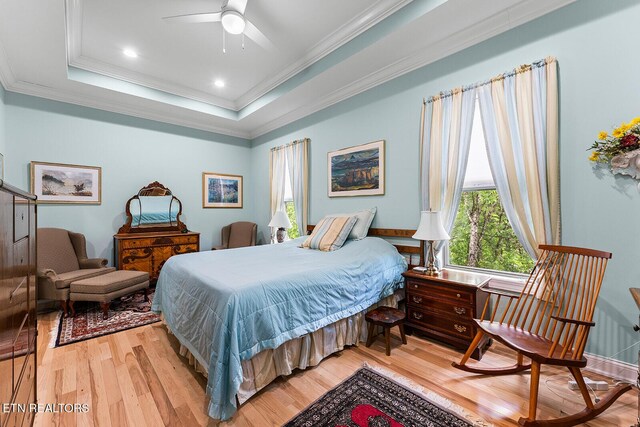 112 Naduli Trl, Vonore, TN 37885 - bedroom with ornamental molding, a ceiling fan, a tray ceiling, and light wood-style flooring