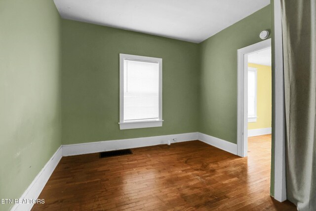 550 Margrave, Harriman, TN 37748 - empty room with a wealth of natural light, baseboards, visible vents, and dark wood finished floors