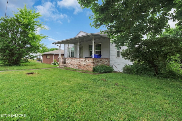 550 Margrave, Harriman, TN 37748 - view of front of home with a porch, brick siding, and a front yard