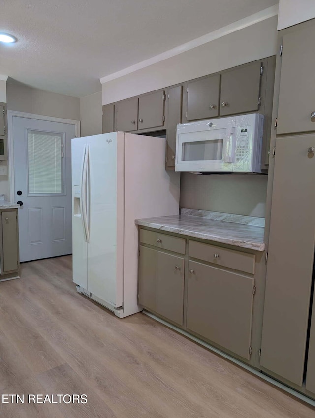 kitchen featuring gray cabinetry, light wood-style flooring, white appliances, and light countertops