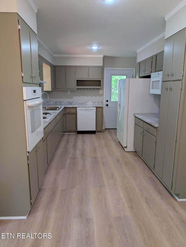 kitchen featuring a sink, gray cabinets, and white appliances