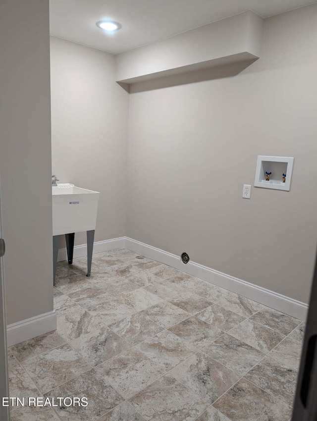 washroom featuring washer hookup, baseboards, and laundry area
