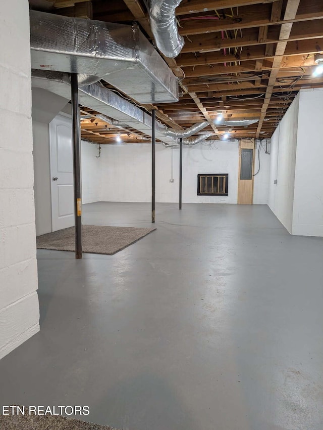 unfinished basement featuring electric panel